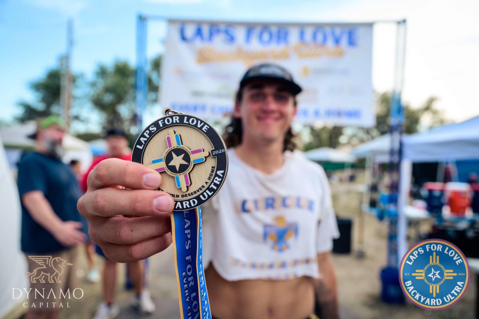 A runner shows off the 2026 finisher medal
