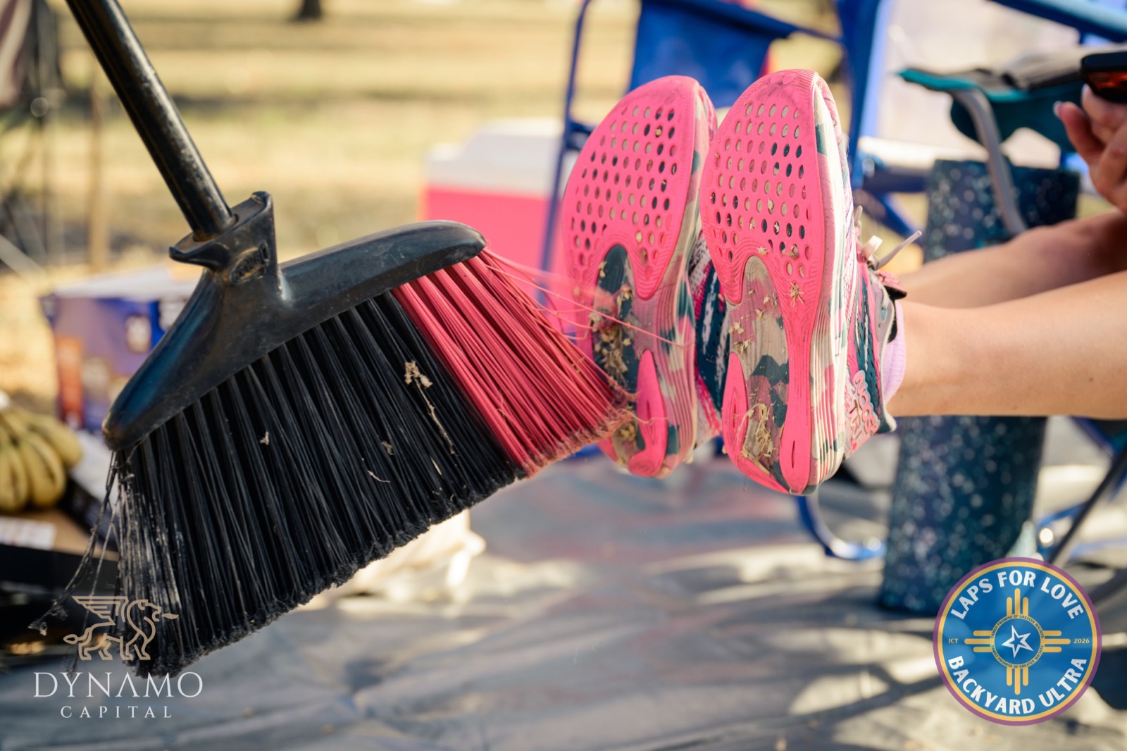 Sweeping grass off a runner's shoes between loops