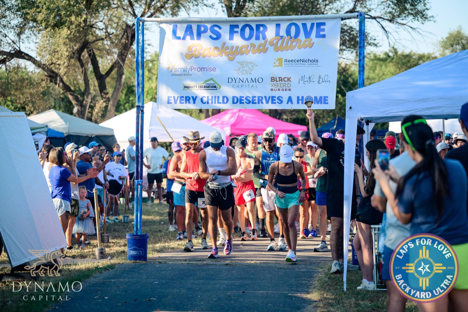 Runners leave the start corral under the Laps For Love banner