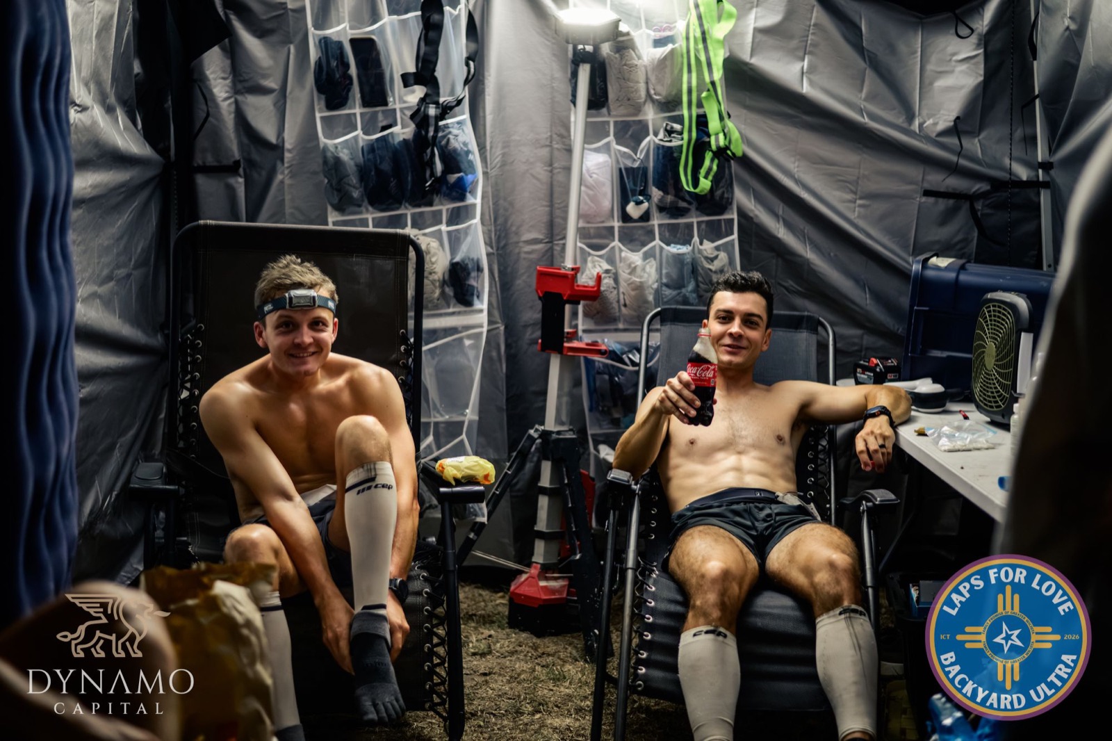 Two runners resting in their crew tent between loops